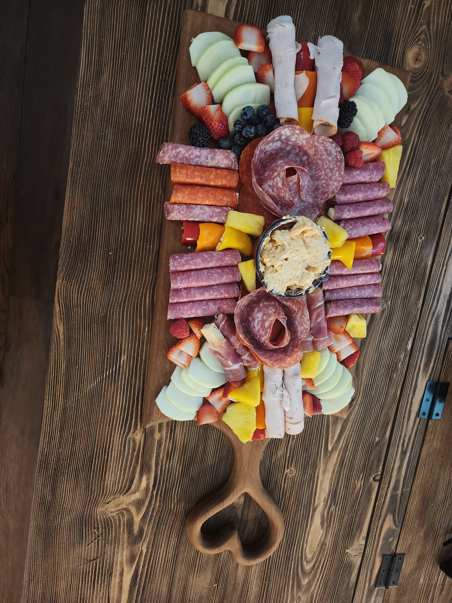 African teak charcuterie board with food